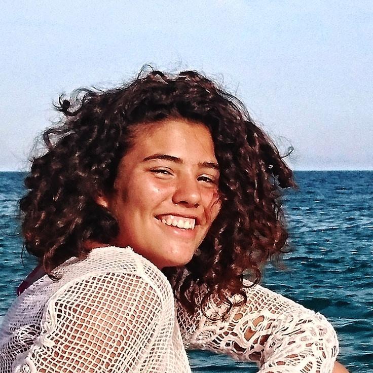 Priya Kapoor, Lead Design Curator at Prisma Lyteven Tures, reviewing corporate floral arrangements